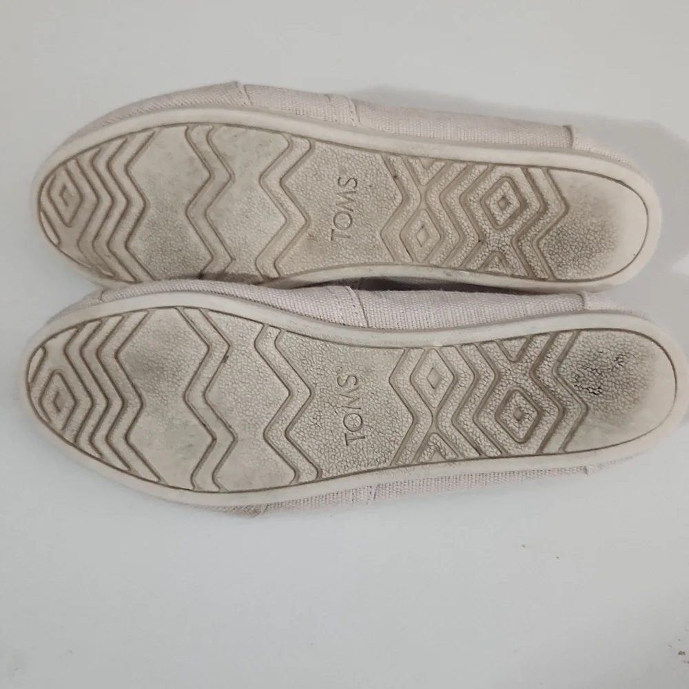 TOMS Shoes Size 9.5 Cream Canvas Slip-On has spots flaws